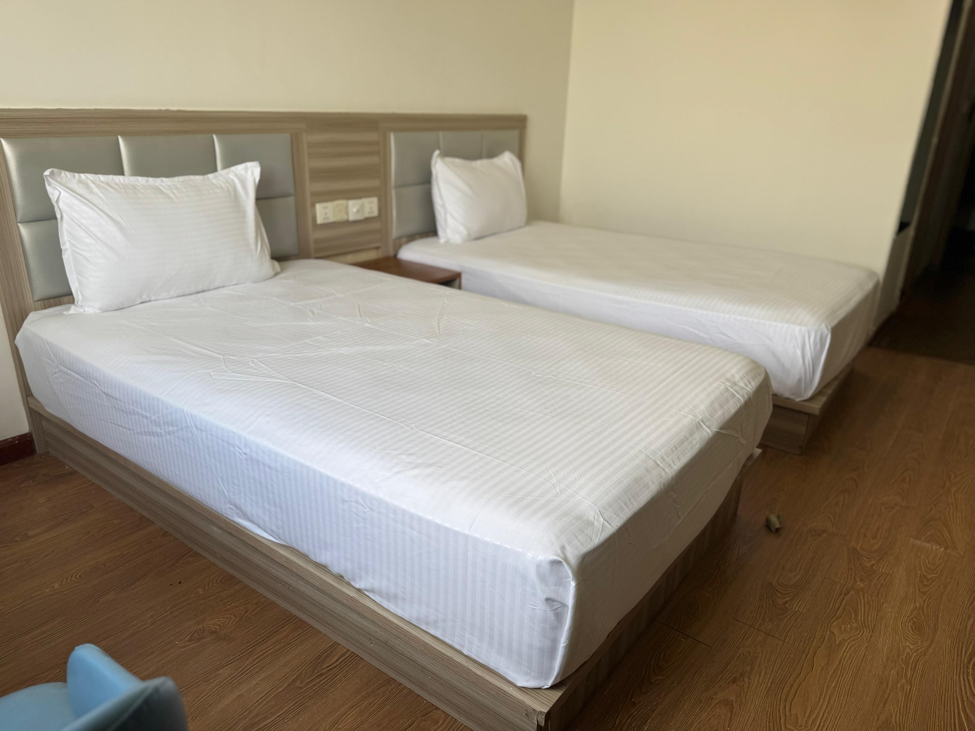 Twin sharing room with two single beds at Nestro Housing co-living, Gurgaon
